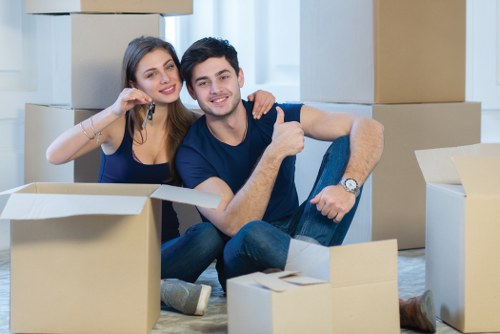Professional movers packing items in a Kennington home.